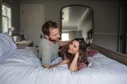 couple laying in bed - ovulation and hormone tracking for conception - WeNatal prenatal